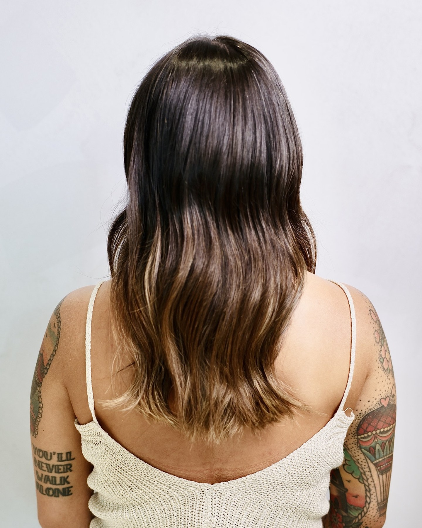 Dopo: extension a tessitura con balayage caramello, lunghezza e volume pieni